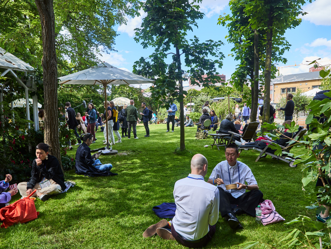 people at the festival area on the grass outside 