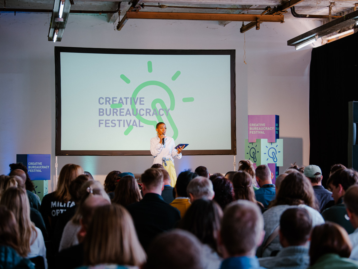 Moderator on stage in front of the audience