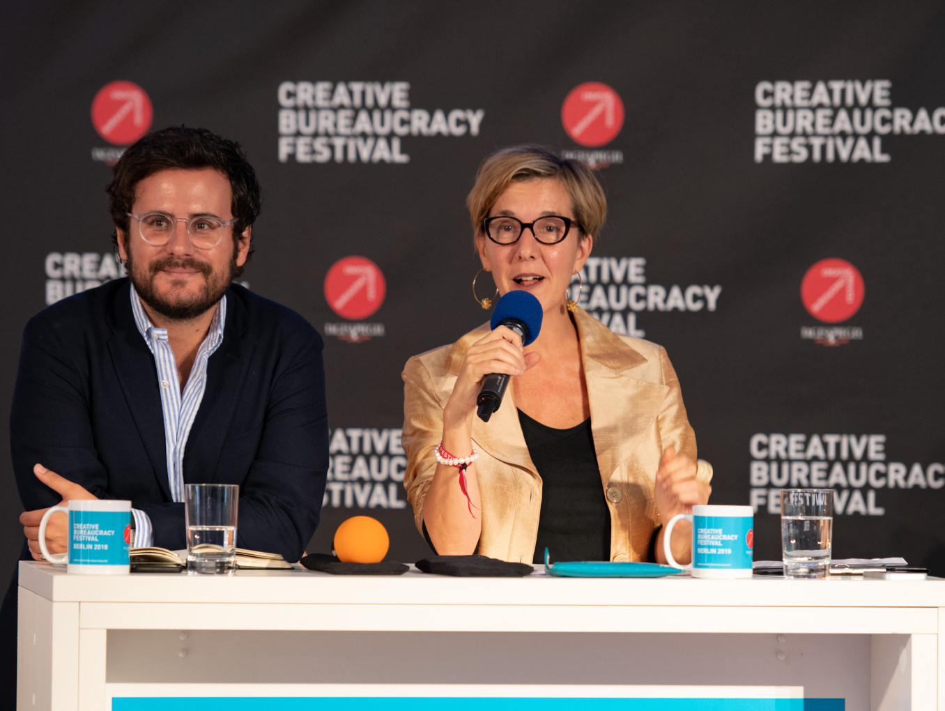 two speakers (man and woman) on stage 