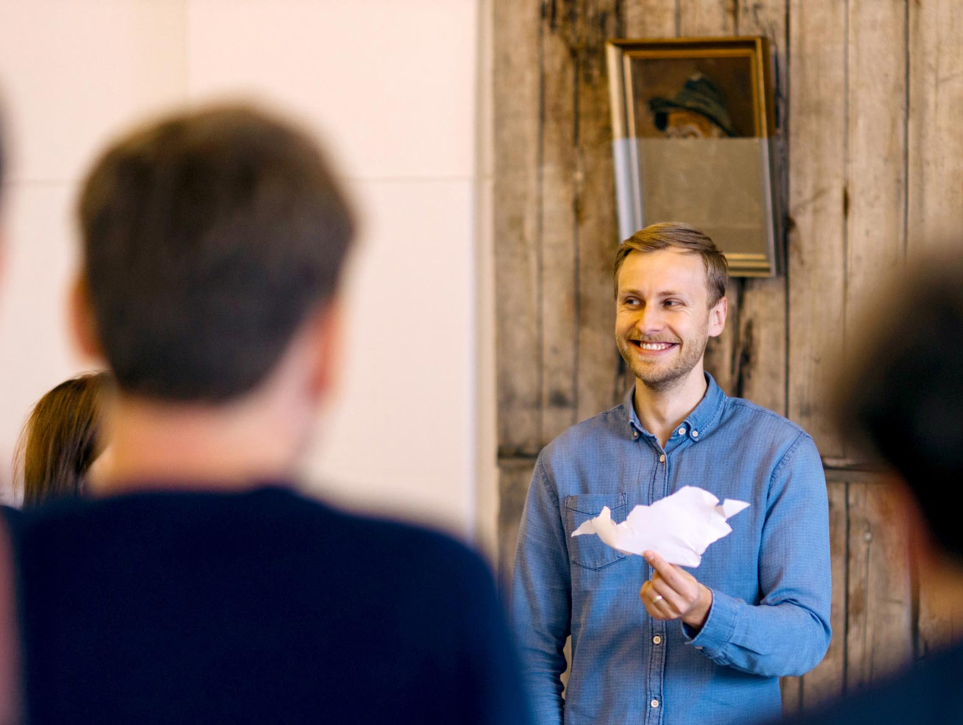 a person presenting their prototype paper airplane