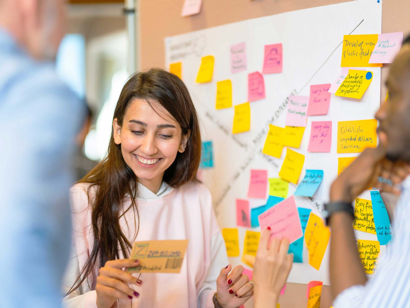A person excitedly looking at a note among others in the group