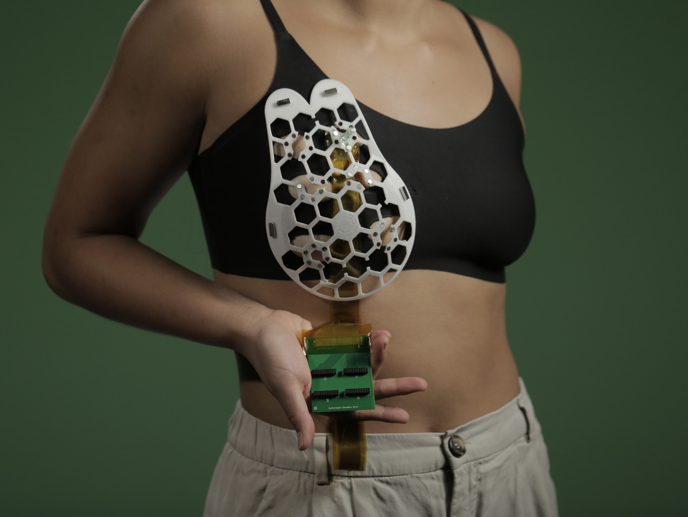 Conformable ultrasound breast patch with nature-inspired honeycomb template on a sports bra.