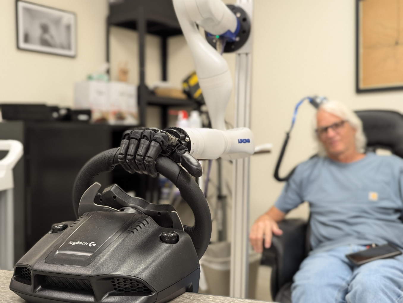 BCI participant with paralysis using a brain-controlled bionic hand with sensory feedback to steer a wheel