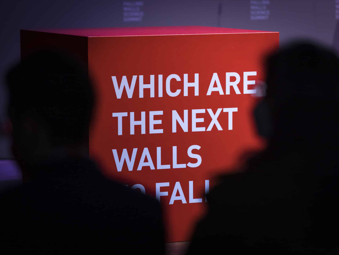 A cube at Science Summit 2021 with wirting on it: WHICH ARE THE NEXT WALLS TO FALL?
