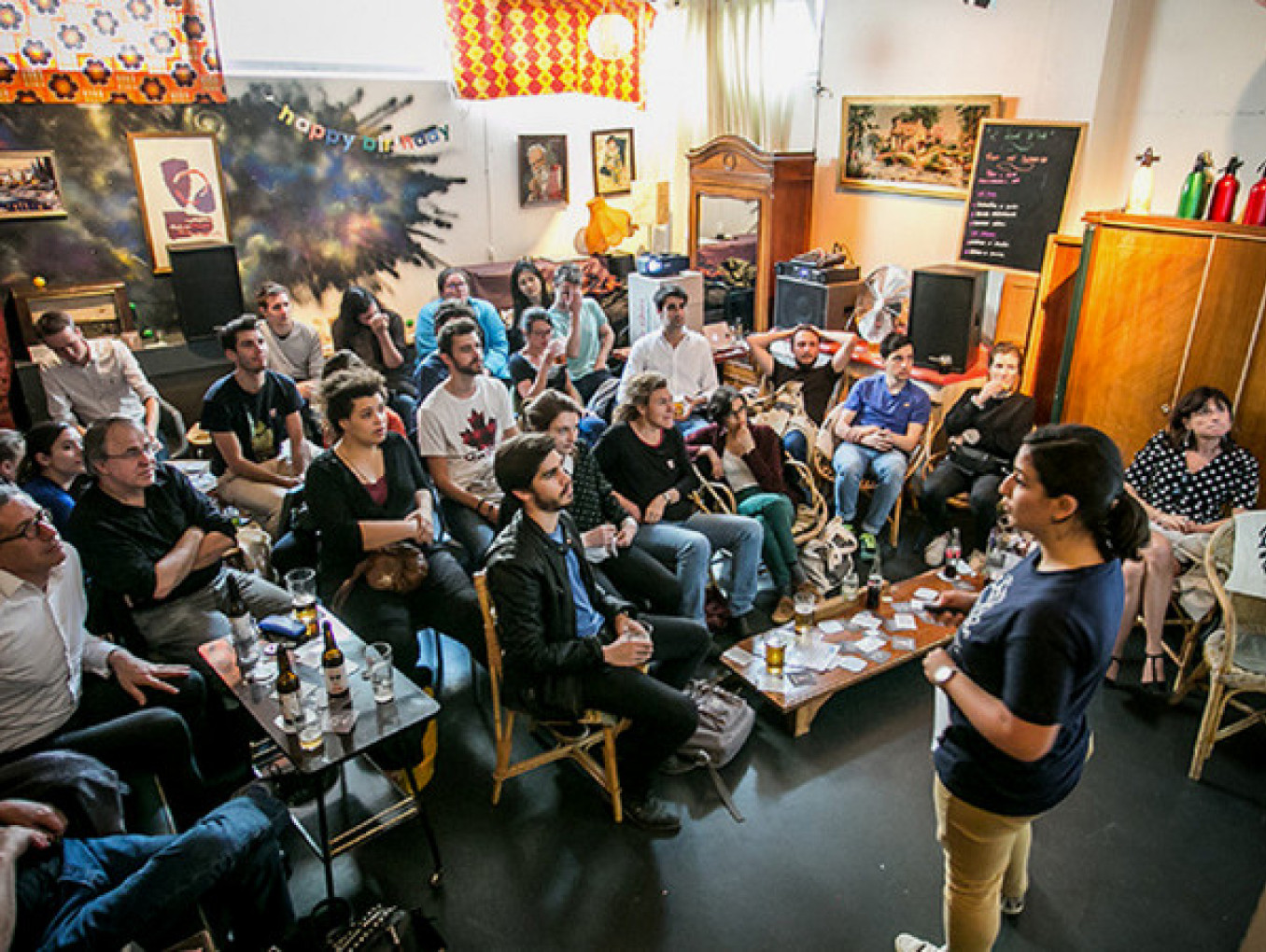 A person is presenting in front of people at bar