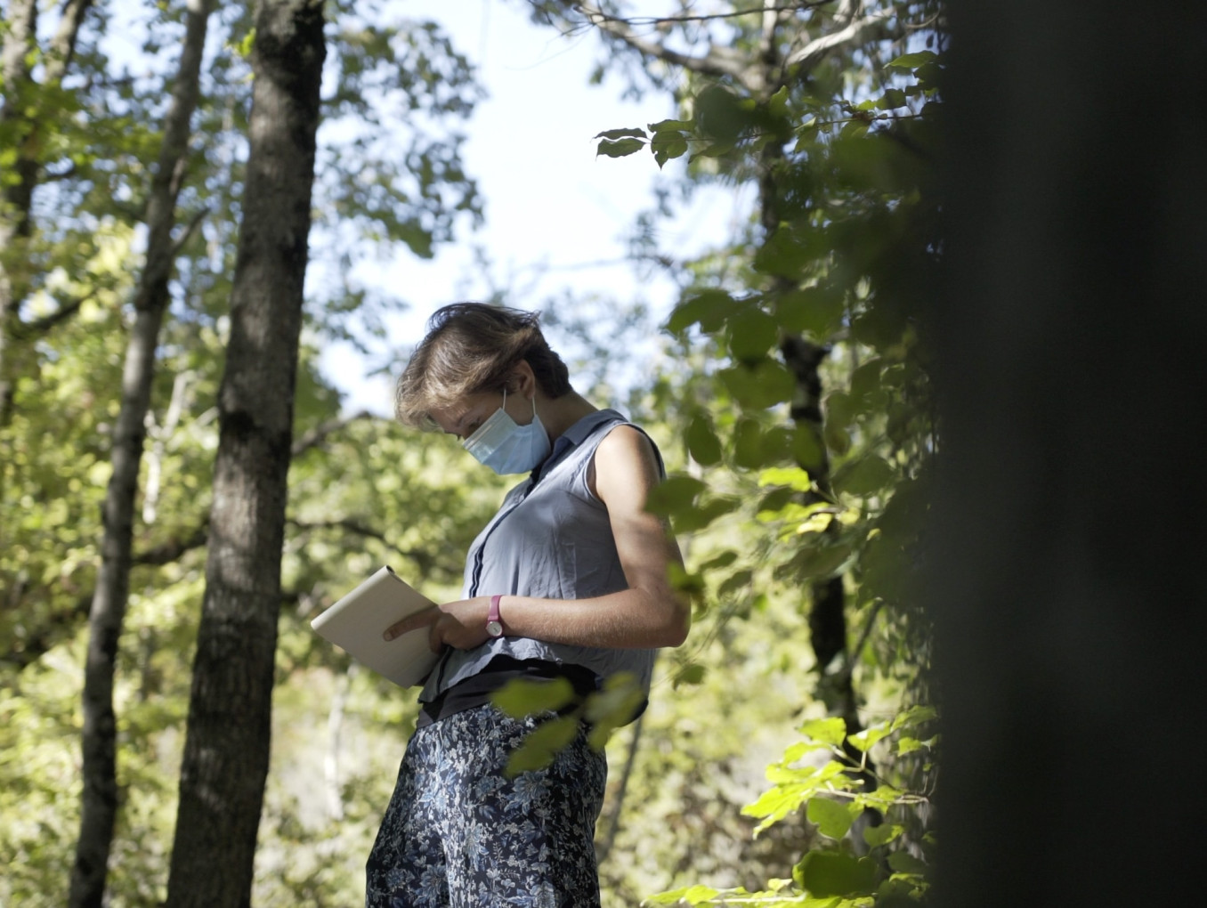 Anna Berti Suman is writing notes in woods