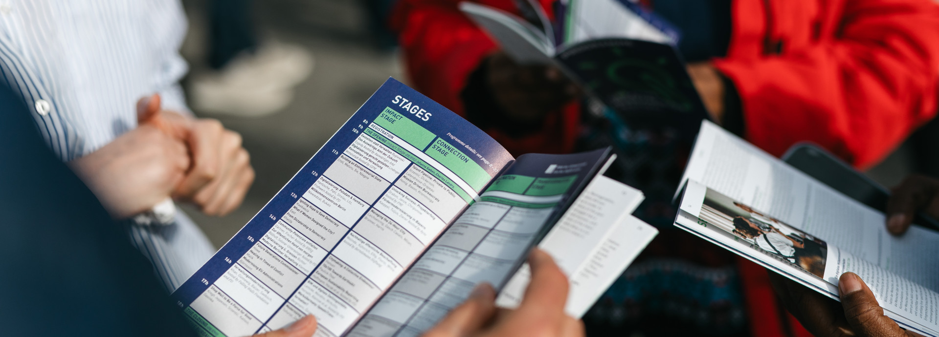 hands holding the festival Programm 