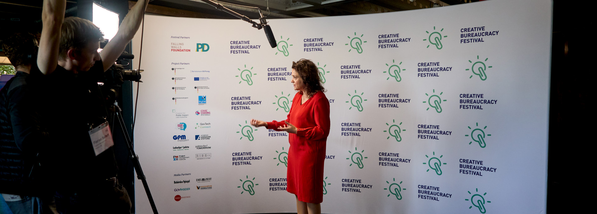 interview of Sarah Ryglewski infront of the press wall