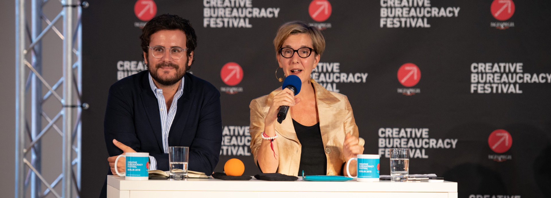 two speakers (man and woman) on stage 