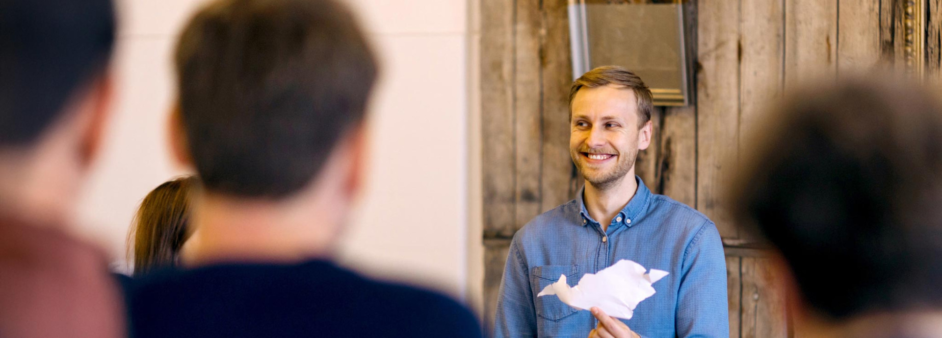 a person presenting their prototype paper airplane