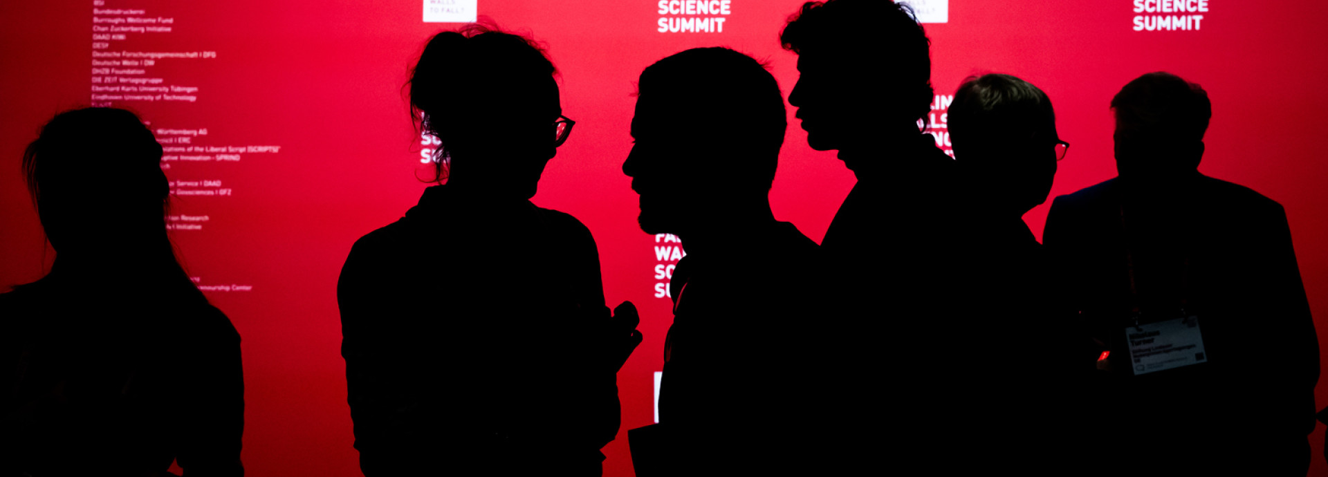 People in front of the press wall at Falling Walls Science Summit