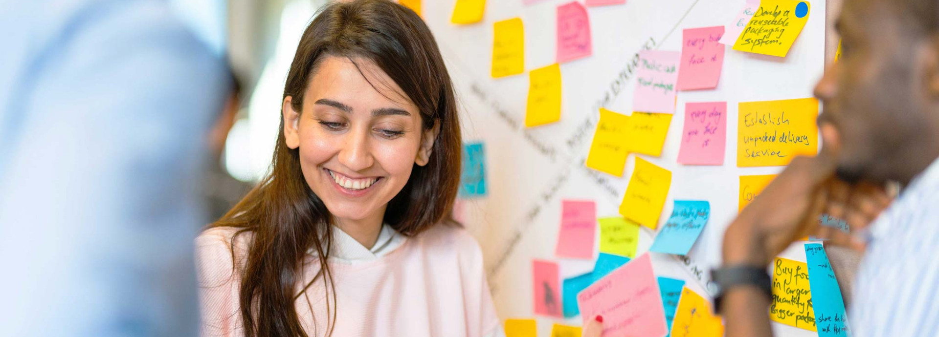 A person excitedly looking at a note among others in the group
