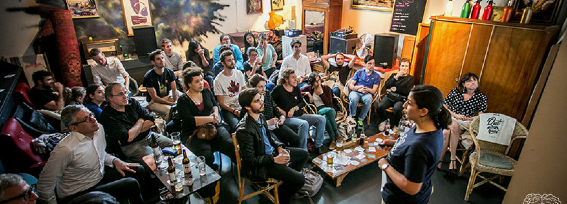 A person is presenting in front of people at bar