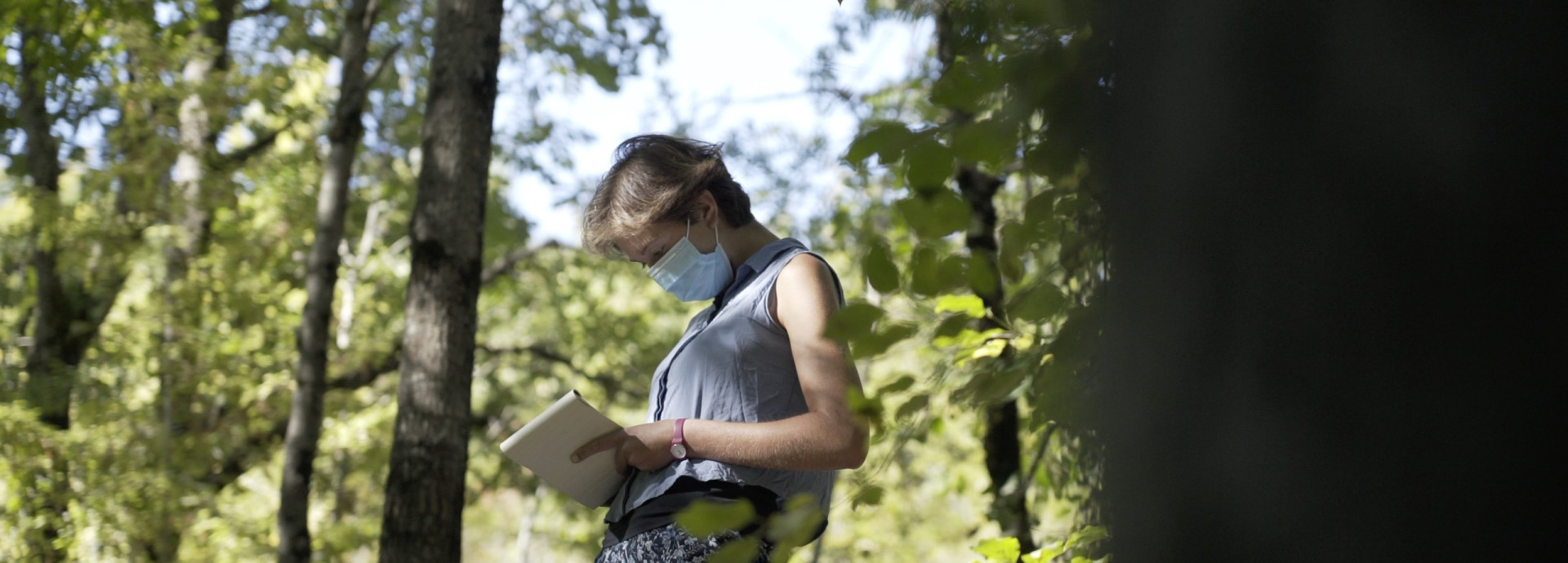 Anna Berti Suman is writing notes in woods
