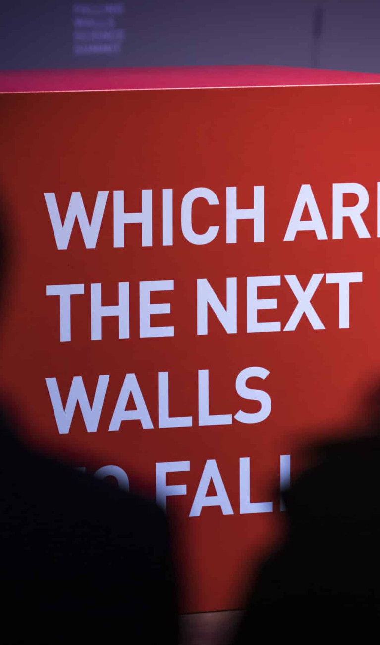 A cube at Science Summit 2021 with wirting on it: WHICH ARE THE NEXT WALLS TO FALL?