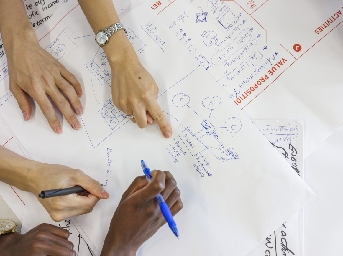 Hands from a bird's perspective working on solutions for water security