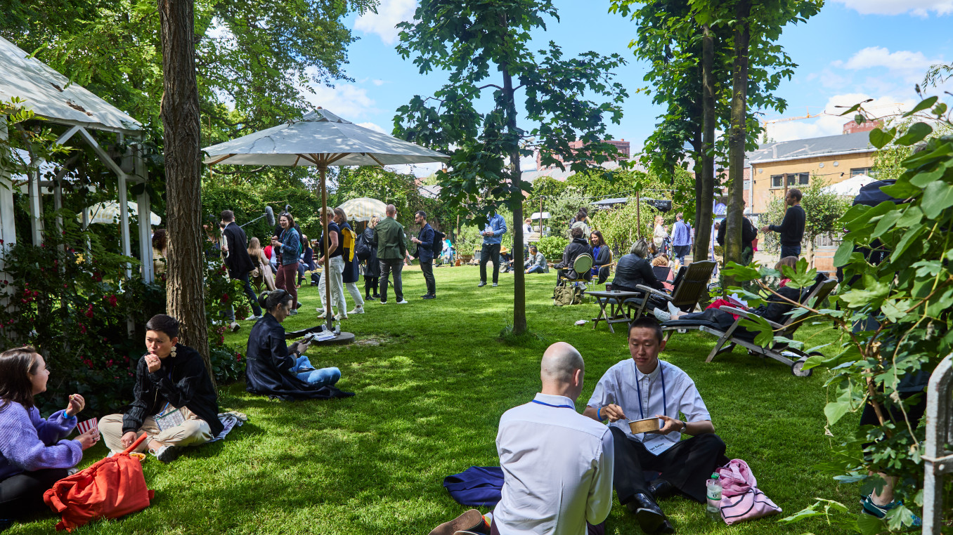 people at the festival area on the grass outside 